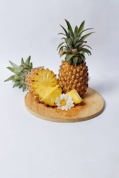Egész ananász izolálva, fényes háttérrel. Közelkép a friss és ízletes ananász. A túlérett, rothadó ananász édes, mézszerű folyadékot szabadít fel. Összpontosítás elmosódott. Ananászos mockup. - Fotó, kép