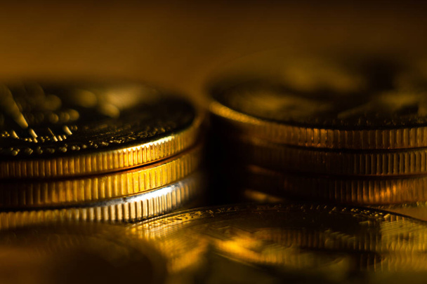 A closeup shot of cryptocurrency gold cash coin stacks - Fotó, kép