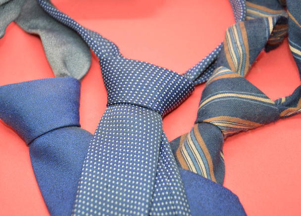 Composition with knotted men's ties with cushions on a the background - Photo, Image