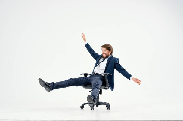 business man rolling in a chair in  office. High quality photo - Фото, изображение