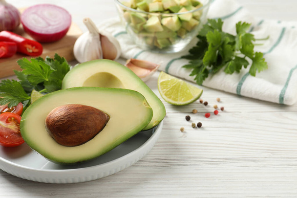 Fresh ingredients for guacamole on white wooden table - Fotó, kép