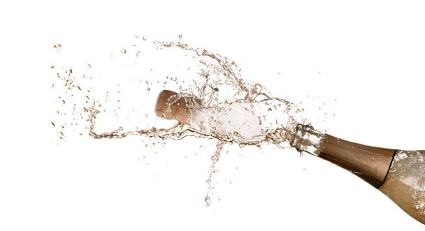 Sparkling wine splashing out of bottle on white background - Photo, image