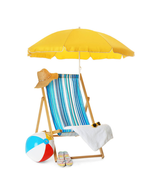 Open yellow beach umbrella, deck chair, inflatable ball and accessories on white background - Photo, Image