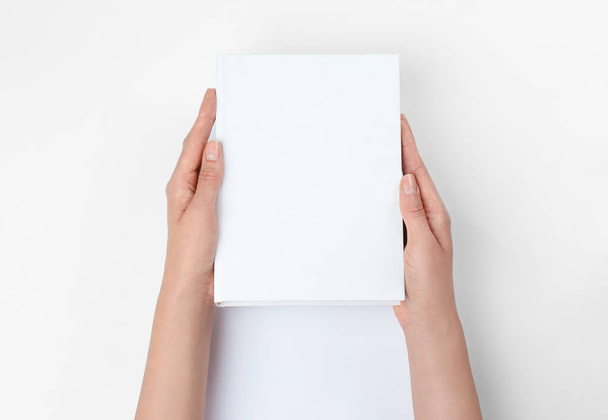 Woman holding book with blank cover on white background, closeup. Space for design - Foto, immagini