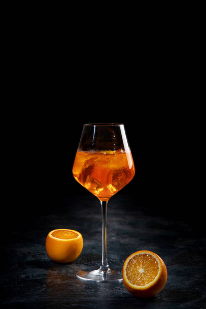 Aperol spritz cocktail served on dark background. Classic drink menu concept. Front view - Foto, Imagen