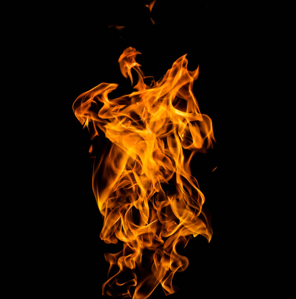 Close up photo of yellow flames coming from a burning gasoline. isolated on Black background.  - Fotó, kép