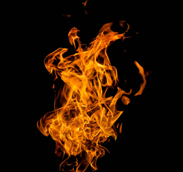 Close up photo of yellow flames coming from a burning gasoline. isolated on Black background.  - Fotó, kép