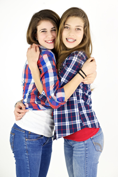 Two happy girlfriends hugging in studio - Foto, Imagen
