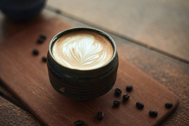 Selective focus cup of hot latte art coffee,focus at white foam - Φωτογραφία, εικόνα