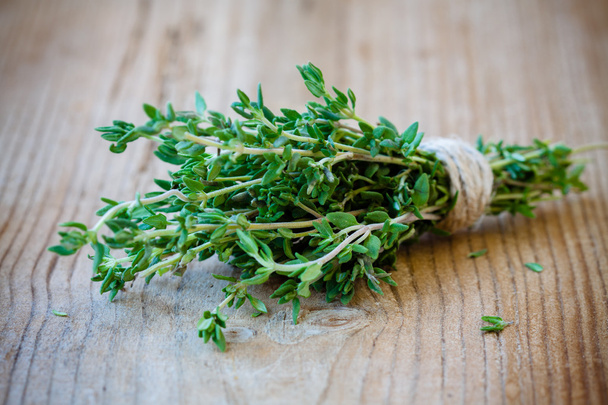 bunch of fresh thyme on a wooden background - Photo, Image