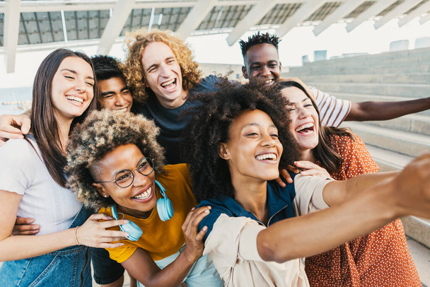 Group of young multicultural people taking selfie portrait with phone - Photo, Image