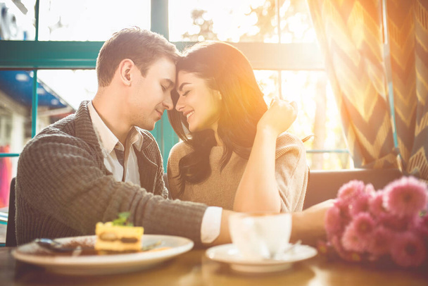 A boldog párnak romantikus randija van egy kávézóban. - Fotó, kép