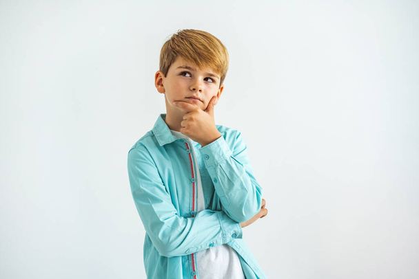 The pensive boy standing on the white background - Foto, immagini