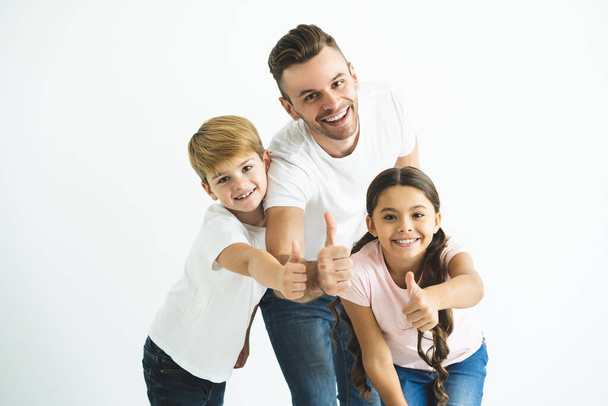 The father and kids gesture on the white background - 写真・画像