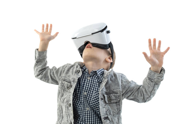Young boy with virtual reality glasses isolated on white background. A child in emotional excitement wearing 3D glasses. - Photo, image