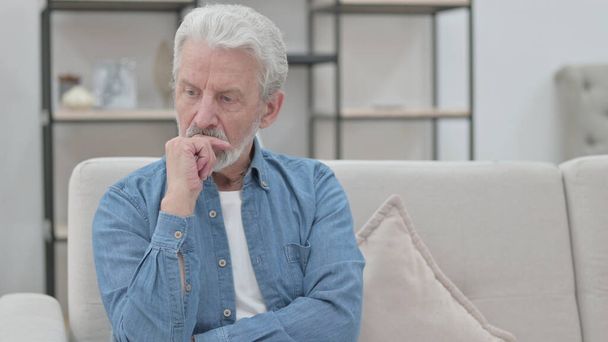 Viejo Pensando mientras está sentado en el sofá  - Foto, Imagen