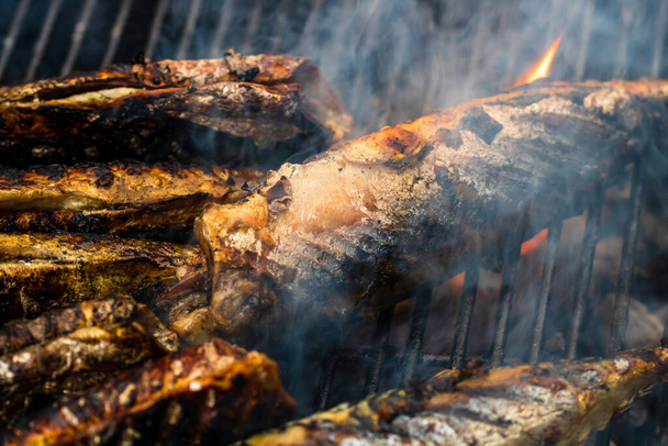 Grilled fish on charcoal grill. Fresh fish barbecue - Photo, Image