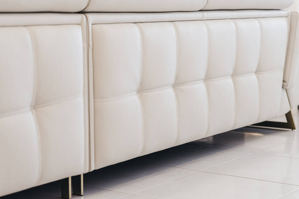 A detail shot of a beige leather couch in a living room - Foto, imagen