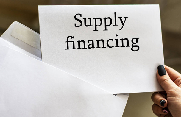 SUPPLY FINANCING words written in letter from envelope. Business concept. - Foto, imagen