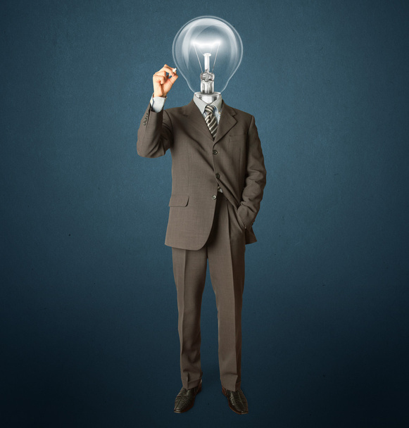 Businessman with lamp-head and marker - Photo, Image