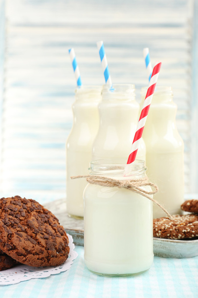 Milk in bottles with paper straws on table - Fotografie, Obrázek