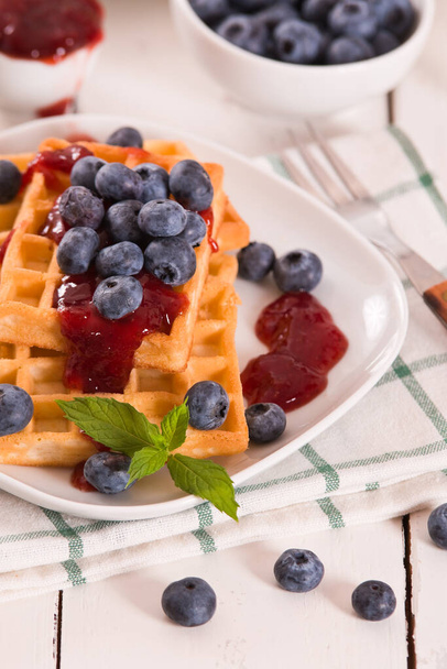 Waffles with blueberries and jam.  - Foto, afbeelding