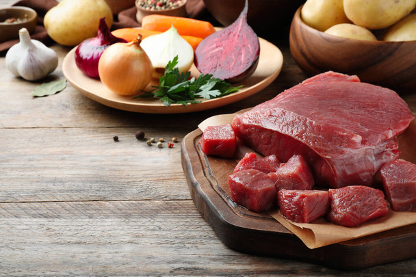 Fresh ingredients for borscht on wooden table, closeup - 写真・画像