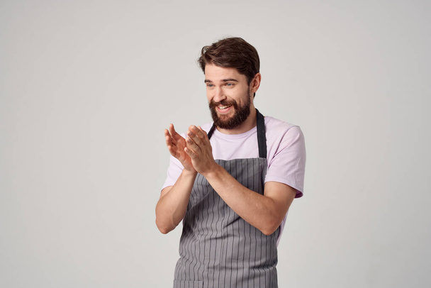 Cheerful male chef in apron  working in a restaurant. High quality photo - Φωτογραφία, εικόνα