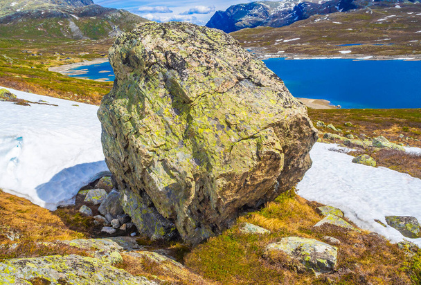 Huge boulder big rock by the beautiful Vavatn lake in the mountains in Hemsedal Viken Norway. - Фото, изображение