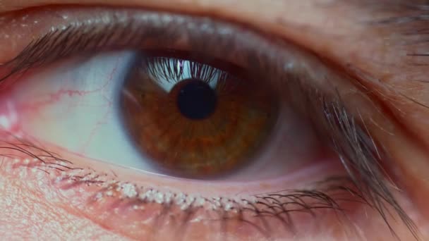 close up iritated eye moving sides - Felvétel, videó