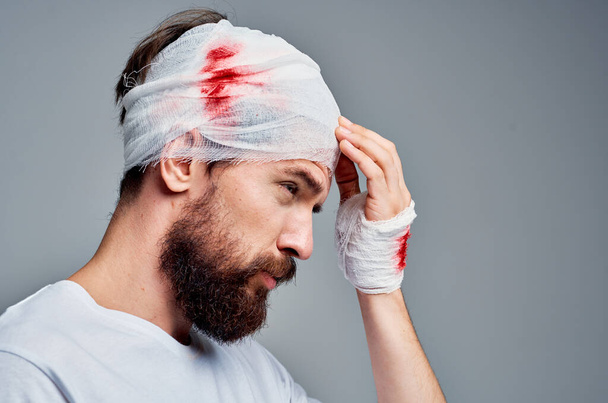 patient bandaged head and hand blood isolated background - Photo, Image