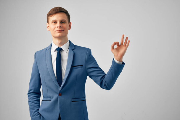 cheerful business man in suit gesturing with hand emotions posing studio - Photo, image