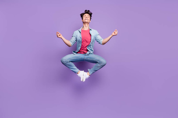 Full length photo of young guy happy positive smile jump yoga zen meditate isolated over purple color background - Foto, imagen