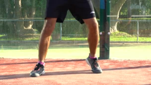 Seville, Spain-03 August, 2021: Slow motion of the legs of a professional paddle tennis player who is playing a match on an outdoor court. - Video