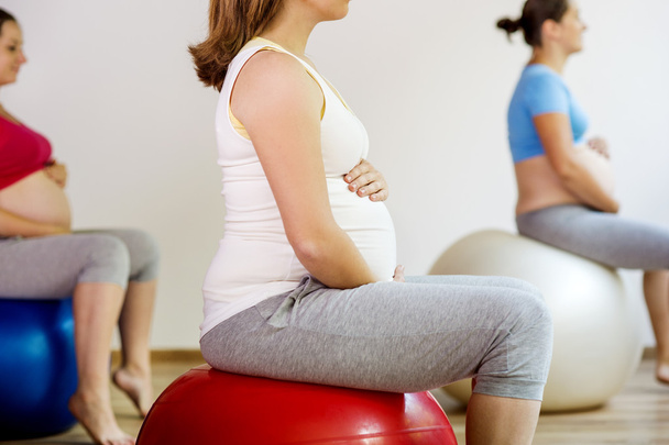 Pregnant women doing exercise - Photo, image