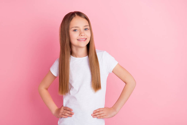 Photo of nice blond little girl wear white t-shirt isolated on pink color background - Foto, Imagem