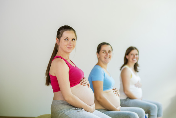 Pregnant women doing exercise - Фото, изображение