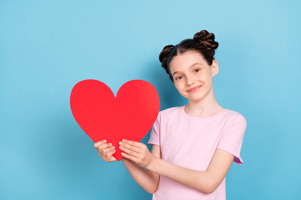 Photo of cheerful young happy positive little girl hold hands red paper heart isolated on blue color background - Фото, изображение