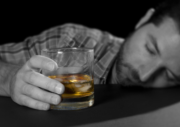  alcoholic man lying drunk with whiskey glass in alcohol addiction and alcoholism concept - Photo, Image