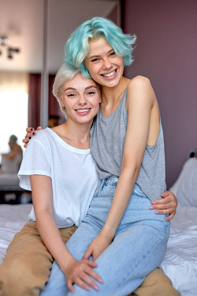 Portrait of happy lesbian couple having fun in bright cozy room together. LGBT concept. - Foto, Imagem