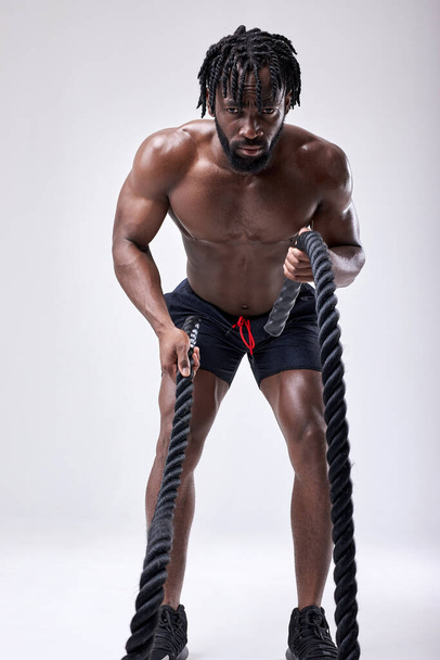 Handsome Motivated African American Guy With Naked Torso Exercising In Studio - 写真・画像
