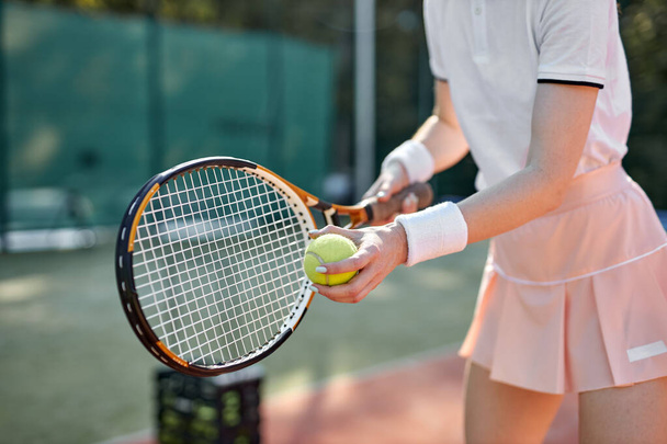 cropped woman playing tennis hitting ball, caucasian athlete female throwing racket - Φωτογραφία, εικόνα