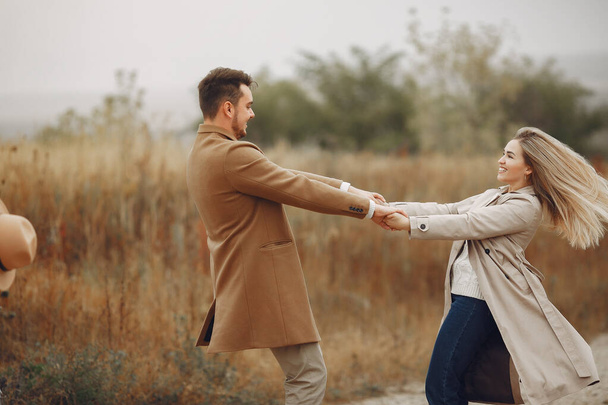 Beautiful couple spend time in a autumn field - Photo, Image