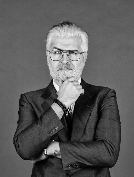 think about future. male beauty and charisma. professional barber at barbershop. agile business. confident businessman wear glasses. mature man dyed beard and hair. grooming for formal meeting - Fotoğraf, Görsel