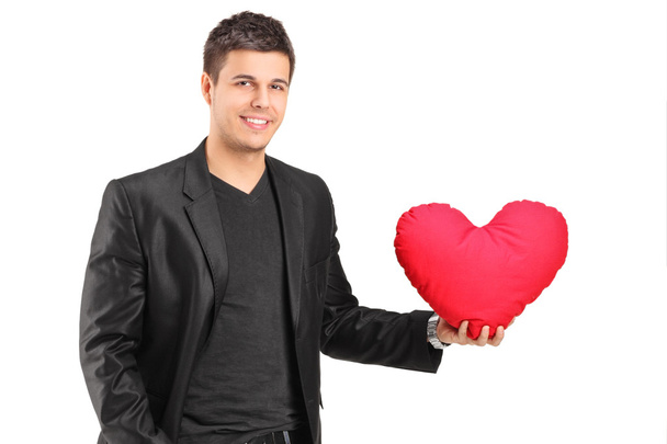 Romantic young man holding heart - Valokuva, kuva