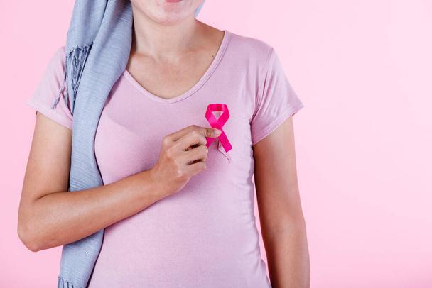 a asian women disease mammary cancer patient in pullover holding pink ribbon isolated on pink blank copy space studio background,healthcare,medicine concept - Φωτογραφία, εικόνα
