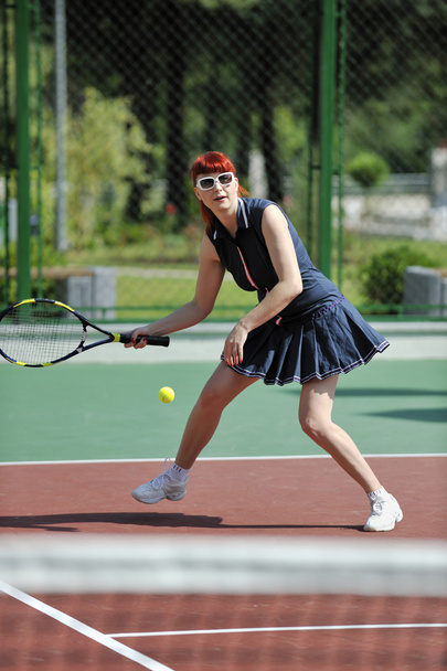 Young fit woman play tennis outdoor on orange tennis field at early morning - Foto, Imagem