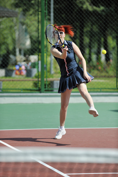 Young woman play tennis game outdoor - 写真・画像