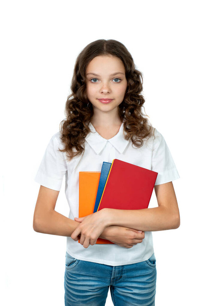 Happy cute student girl in school uniform holding books. Smiling schoolgirl isolated on white. Concept of education, reading, back to school. - Φωτογραφία, εικόνα