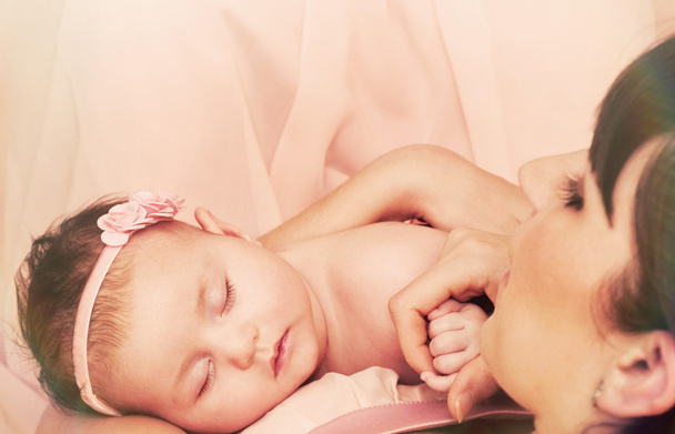 young beautiful mother holding with love her little cute sleepin - Photo, Image